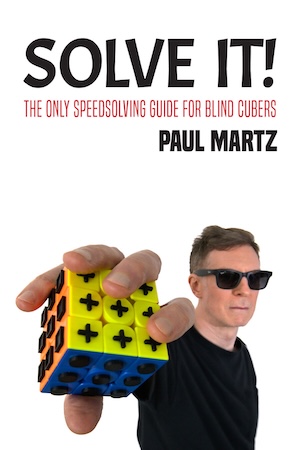 Solve It! cover image, showing Paul holding a tactile cube in front of the camera.
